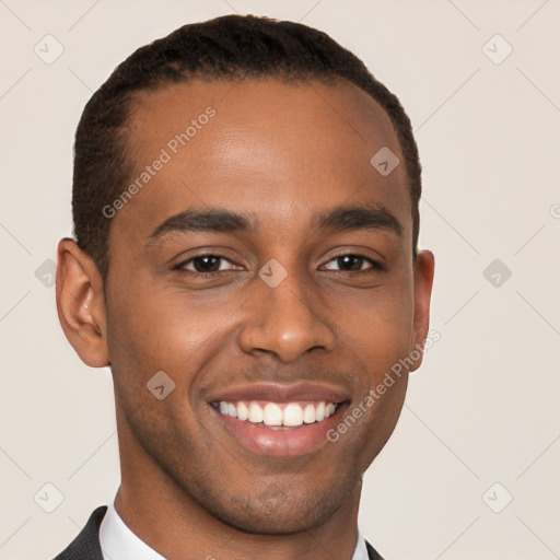 Joyful black young-adult male with short  brown hair and brown eyes