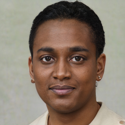 Joyful black young-adult male with short  black hair and brown eyes