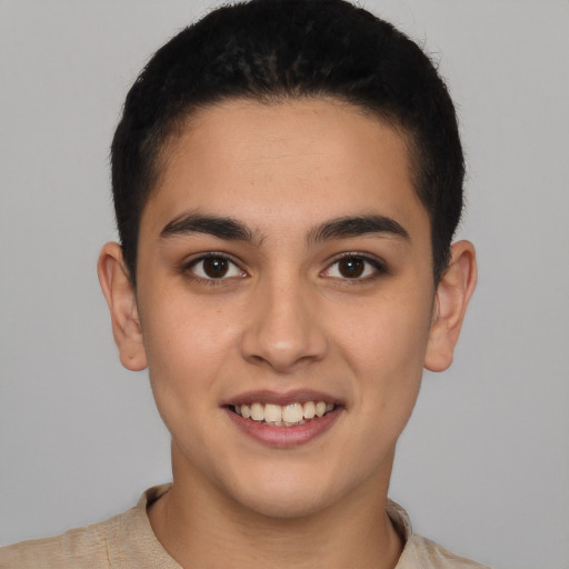 Joyful latino young-adult male with short  brown hair and brown eyes