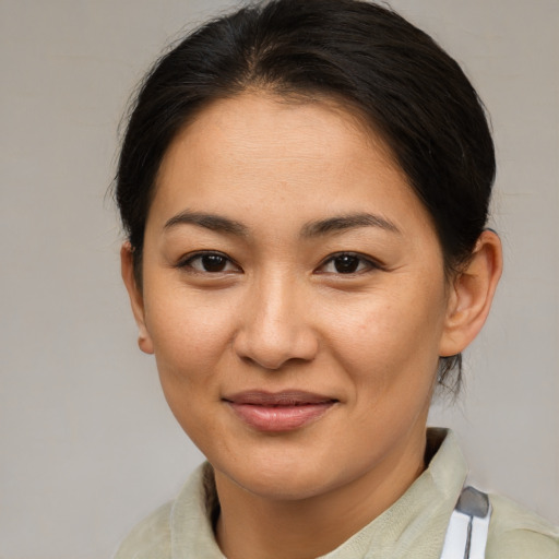 Joyful asian young-adult female with medium  brown hair and brown eyes