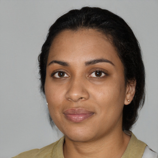 Joyful black young-adult female with medium  black hair and brown eyes