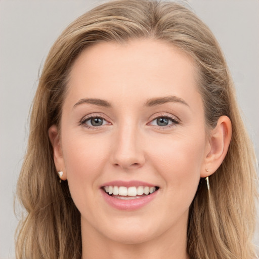 Joyful white young-adult female with long  brown hair and blue eyes