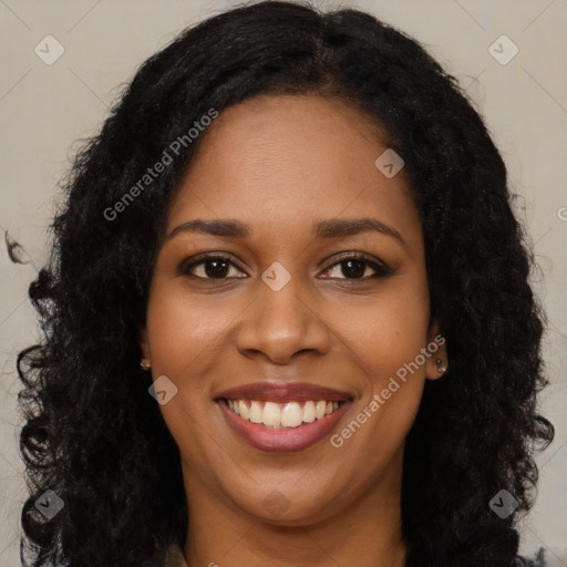 Joyful black young-adult female with long  brown hair and brown eyes