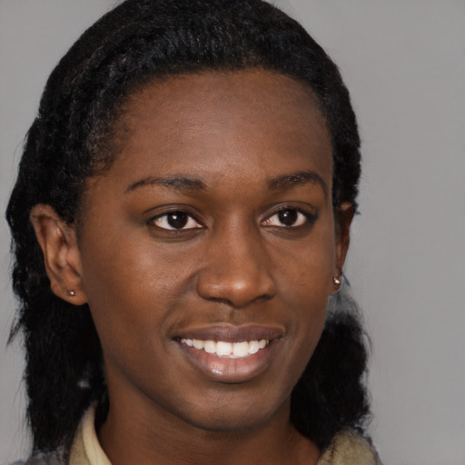 Joyful black young-adult female with medium  brown hair and brown eyes