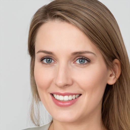 Joyful white young-adult female with long  brown hair and grey eyes