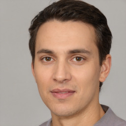 Joyful white young-adult male with short  brown hair and brown eyes