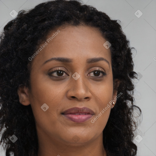 Joyful black young-adult female with long  brown hair and brown eyes