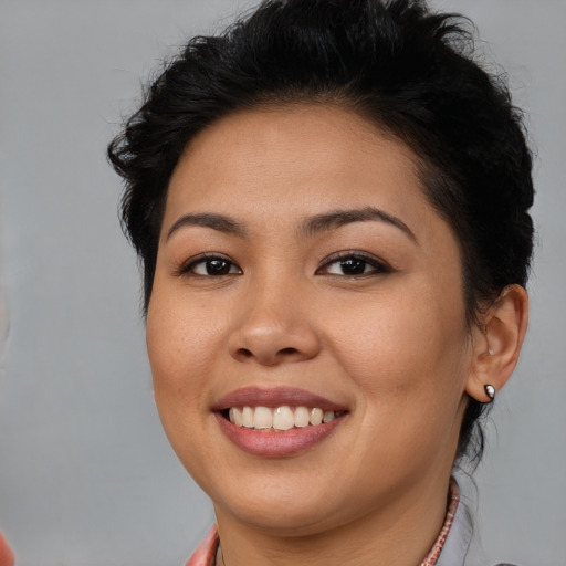 Joyful latino young-adult female with short  brown hair and brown eyes