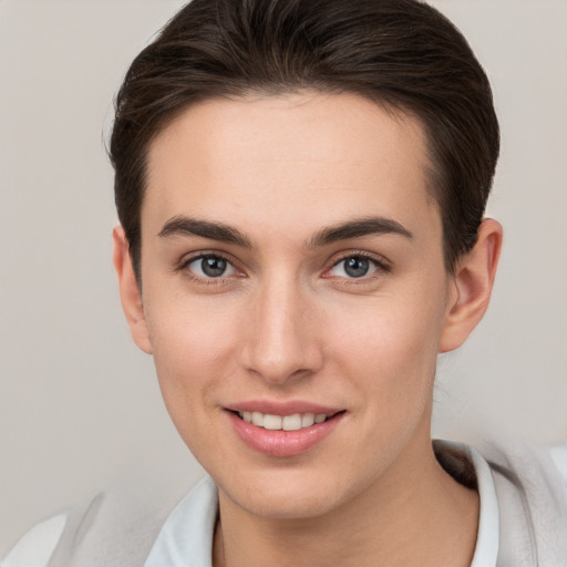 Joyful white young-adult female with short  brown hair and brown eyes