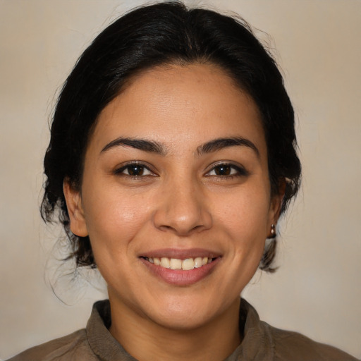 Joyful latino young-adult female with medium  brown hair and brown eyes