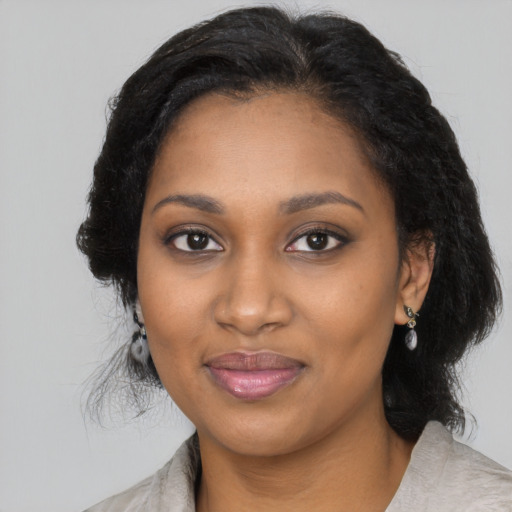 Joyful black young-adult female with medium  black hair and brown eyes