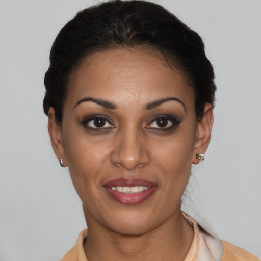 Joyful latino young-adult female with short  black hair and brown eyes