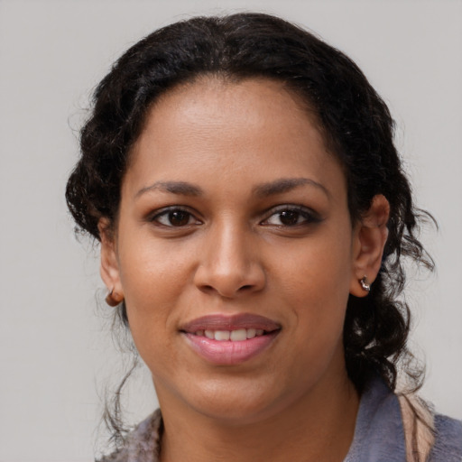 Joyful black young-adult female with medium  brown hair and brown eyes