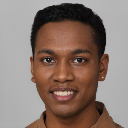 Joyful black young-adult male with short  black hair and brown eyes