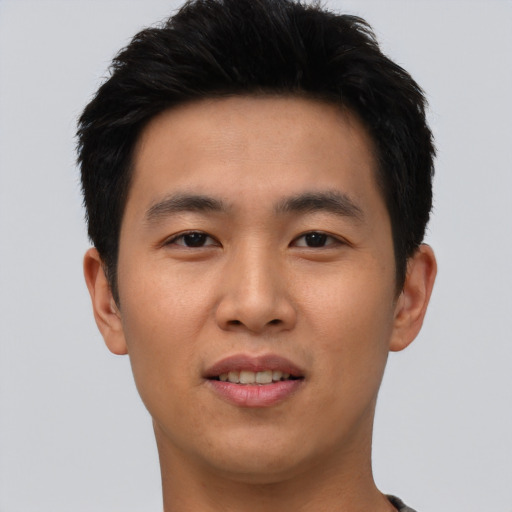 Joyful asian young-adult male with short  black hair and brown eyes