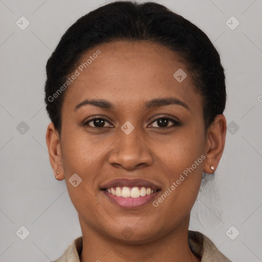 Joyful black young-adult female with short  brown hair and brown eyes