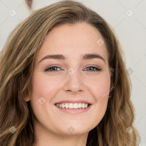 Joyful white young-adult female with long  brown hair and green eyes