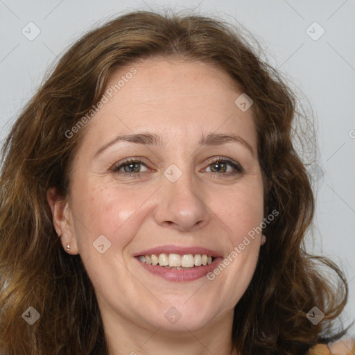 Joyful white adult female with long  brown hair and brown eyes