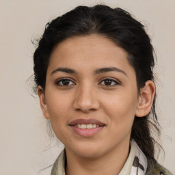 Joyful latino young-adult female with medium  brown hair and brown eyes