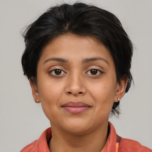 Joyful latino young-adult female with short  brown hair and brown eyes