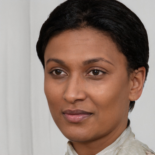 Joyful latino young-adult female with short  black hair and brown eyes