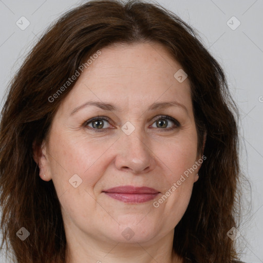 Joyful white adult female with long  brown hair and grey eyes