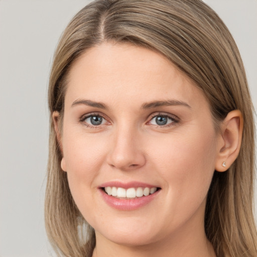 Joyful white young-adult female with long  brown hair and grey eyes