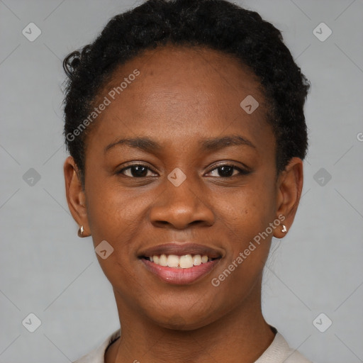 Joyful black young-adult female with short  brown hair and brown eyes