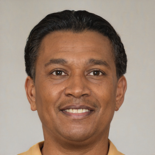 Joyful latino adult male with short  black hair and brown eyes