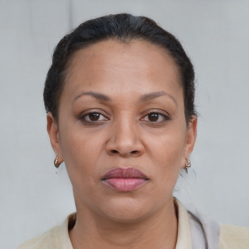 Joyful black adult female with short  brown hair and brown eyes