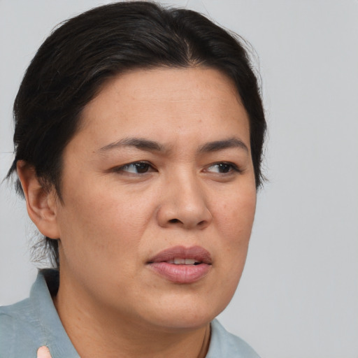Joyful asian adult female with short  brown hair and brown eyes