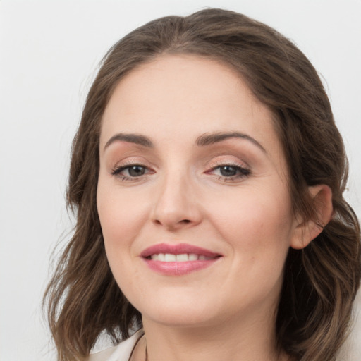 Joyful white young-adult female with medium  brown hair and grey eyes