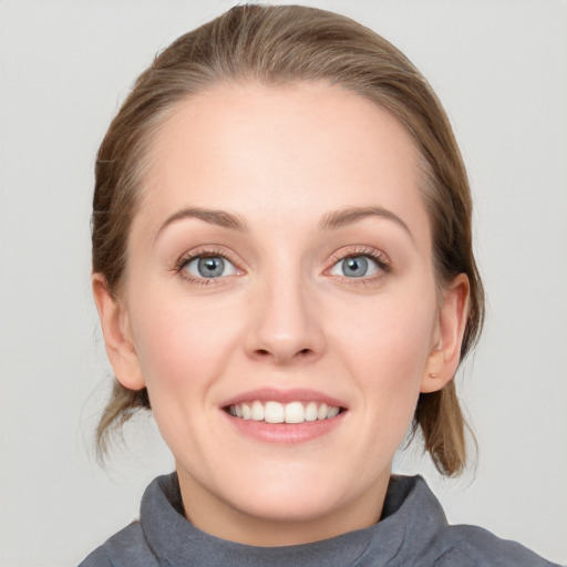 Joyful white young-adult female with medium  brown hair and blue eyes