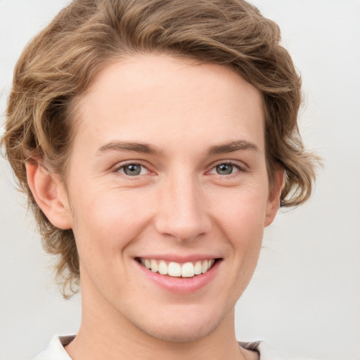 Joyful white young-adult female with short  brown hair and grey eyes