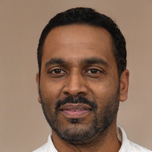 Neutral latino adult male with short  black hair and brown eyes