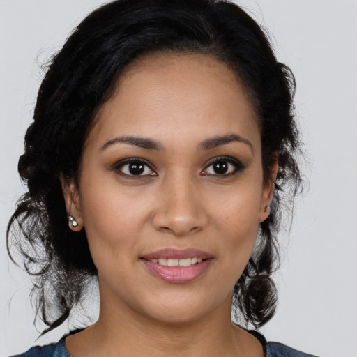 Joyful latino young-adult female with medium  brown hair and brown eyes