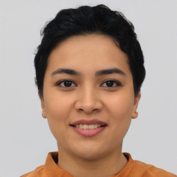 Joyful asian young-adult female with short  black hair and brown eyes