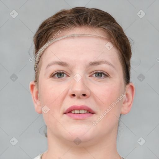 Joyful white young-adult female with short  brown hair and grey eyes