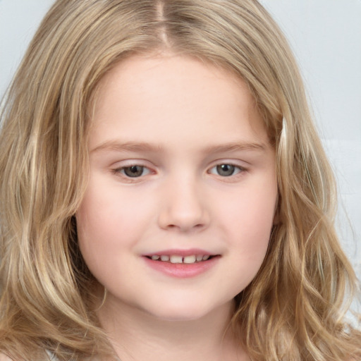 Joyful white child female with long  brown hair and brown eyes