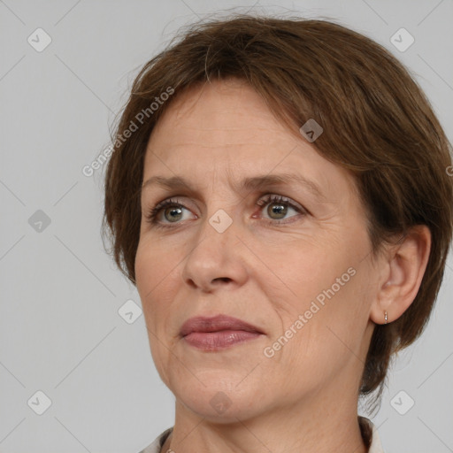 Joyful white adult female with medium  brown hair and grey eyes