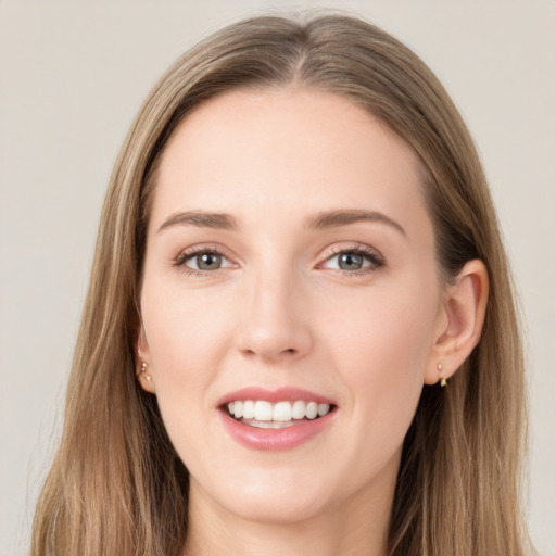 Joyful white young-adult female with long  brown hair and grey eyes