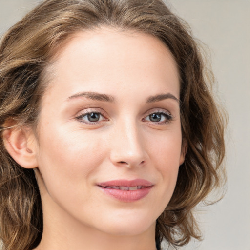 Joyful white young-adult female with long  brown hair and green eyes