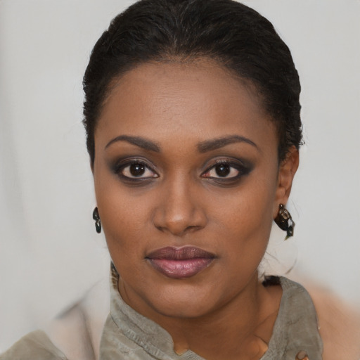 Joyful black young-adult female with short  black hair and brown eyes