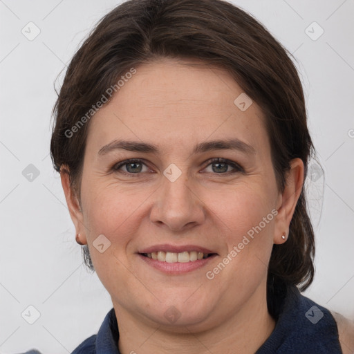 Joyful white adult female with medium  brown hair and grey eyes