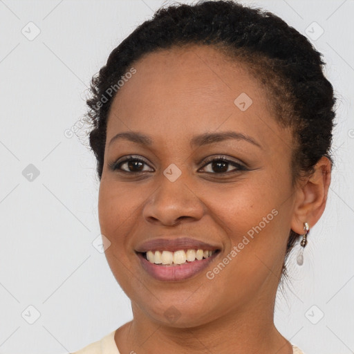 Joyful black young-adult female with short  brown hair and brown eyes