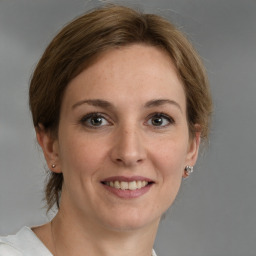 Joyful white adult female with medium  brown hair and grey eyes