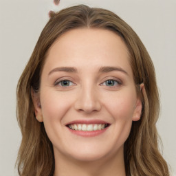 Joyful white young-adult female with long  brown hair and green eyes