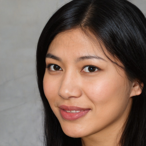 Joyful white young-adult female with long  black hair and brown eyes