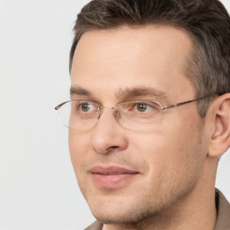 Joyful white adult male with short  brown hair and brown eyes