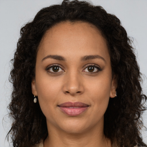 Joyful latino young-adult female with long  brown hair and brown eyes